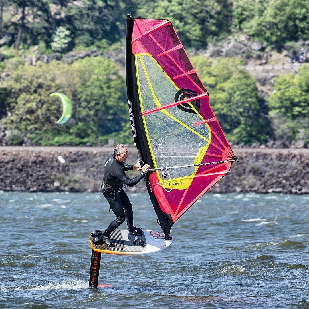Tony Logosz windfoiling on the Columbia River at Hood River, flying a foil under a windsurf sail