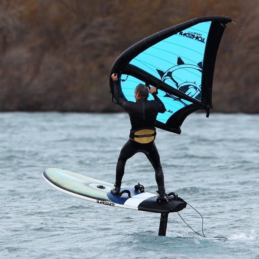 Tony Logosz flying a Slingwing on a foil board, clear of the water, November 2015