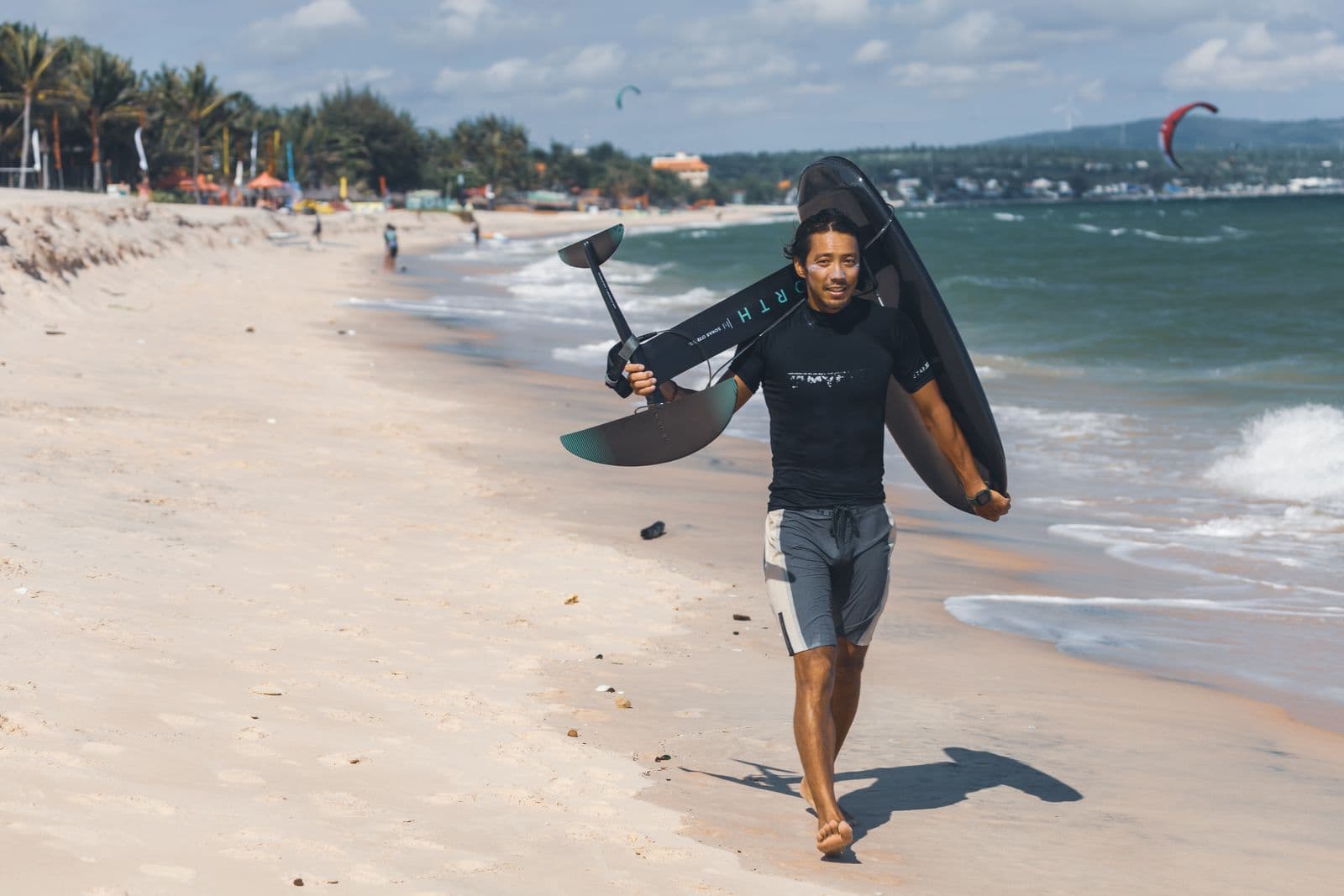 A beginner wing foil setup on the beach — board, REVSTAR foil and inflatable wing